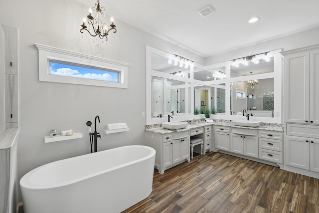 bathroom with a sink, a shower stall, and a chandelier