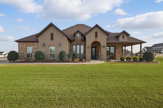 french country inspired facade featuring a front lawn and roof with shingles