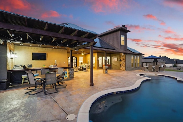 view of pool featuring a patio and outdoor dining area