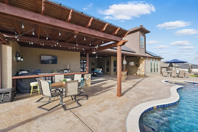 view of patio with outdoor dining space and an outdoor pool