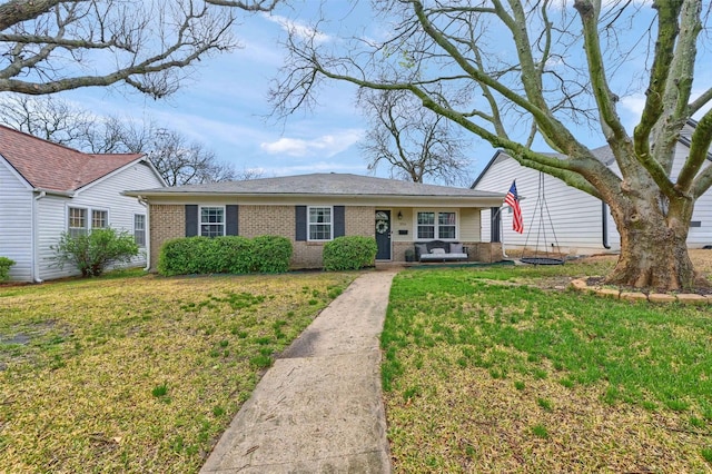 ranch-style home with a front lawn and brick siding