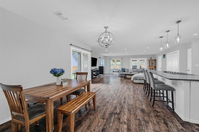dining space with recessed lighting, visible vents, dark wood-type flooring, baseboards, and a chandelier
