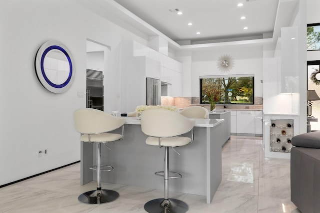 kitchen with white cabinets, modern cabinets, and marble finish floor