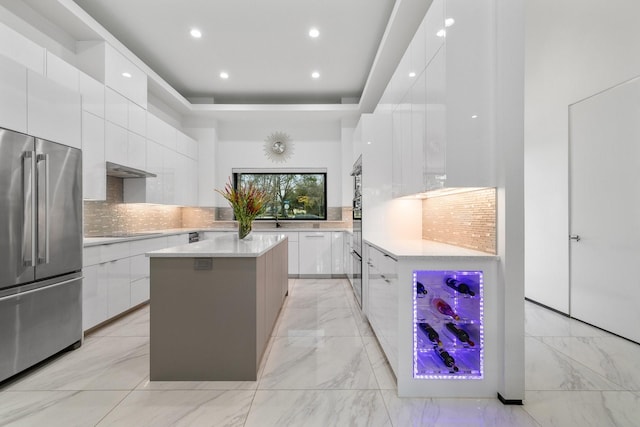 kitchen featuring modern cabinets, high quality fridge, white cabinets, light countertops, and black electric stovetop