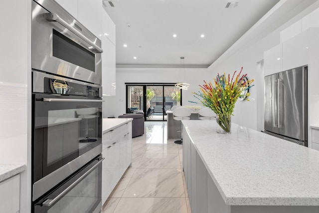 kitchen with a kitchen island, white cabinets, marble finish floor, stainless steel appliances, and modern cabinets