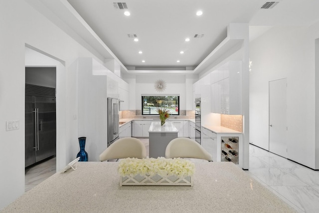 kitchen featuring visible vents, appliances with stainless steel finishes, and white cabinetry