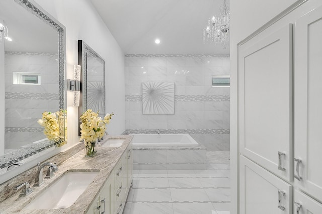 bathroom featuring a sink, a garden tub, double vanity, and vaulted ceiling