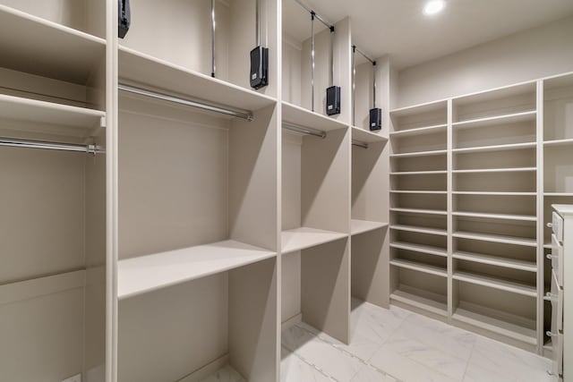 spacious closet with marble finish floor