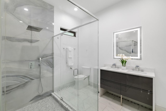 full bathroom with a shower stall, toilet, double vanity, and a sink