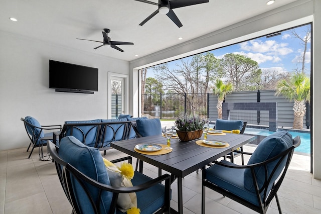 view of patio / terrace with a fenced in pool, outdoor dining area, ceiling fan, and fence