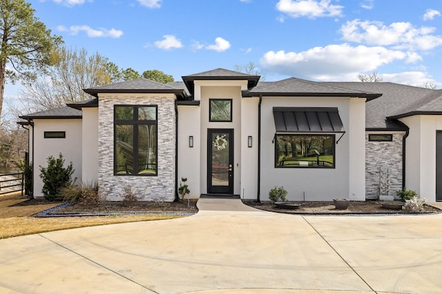 prairie-style house with stone siding and stucco siding