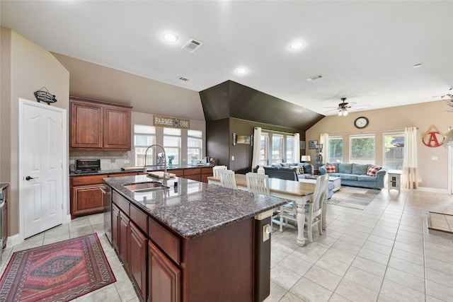 521 Eastbrook Dr, Anna, TX 75409 - kitchen with vaulted ceiling, a ceiling fan, light tile patterned floors, a kitchen island with sink, and plenty of natural light