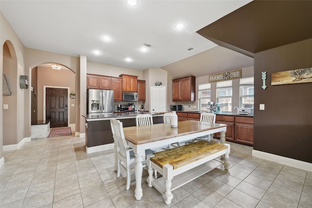 dining space with light tile patterned floors, recessed lighting, baseboards, and lofted ceiling