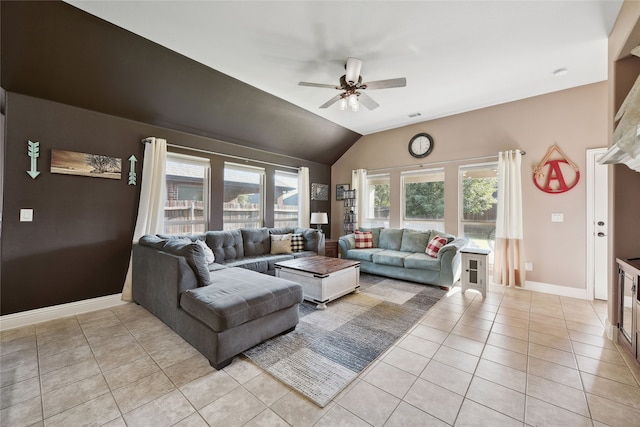 living room with a ceiling fan, baseboards, visible vents, light tile patterned flooring, and vaulted ceiling