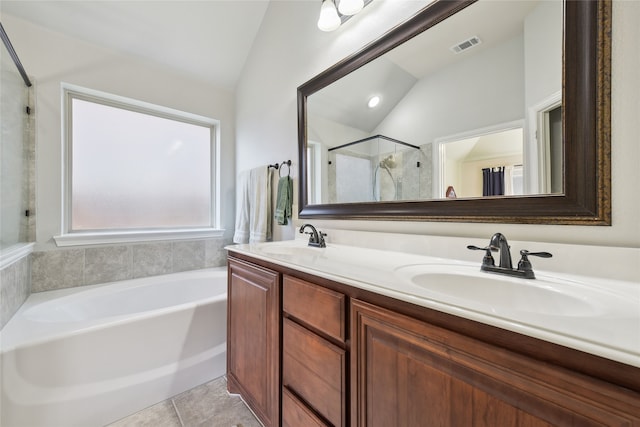 full bath with a sink, visible vents, lofted ceiling, and tile patterned floors