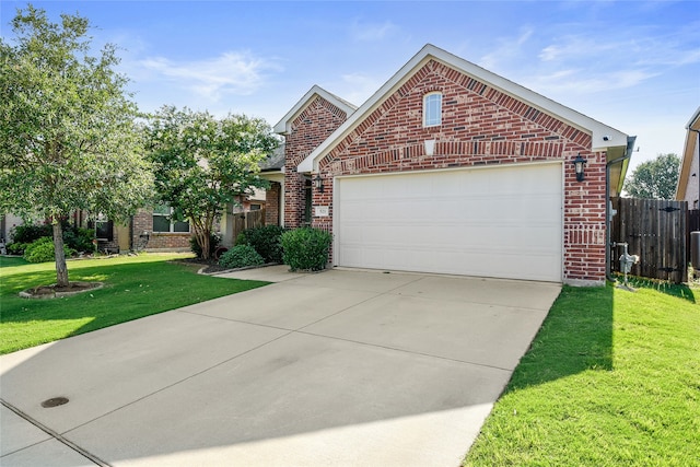 view of front of home featuring brick siding, fence, concrete driveway, a front yard, and a garage