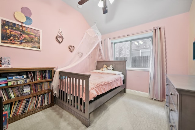 bedroom featuring ceiling fan, vaulted ceiling, baseboards, and light carpet