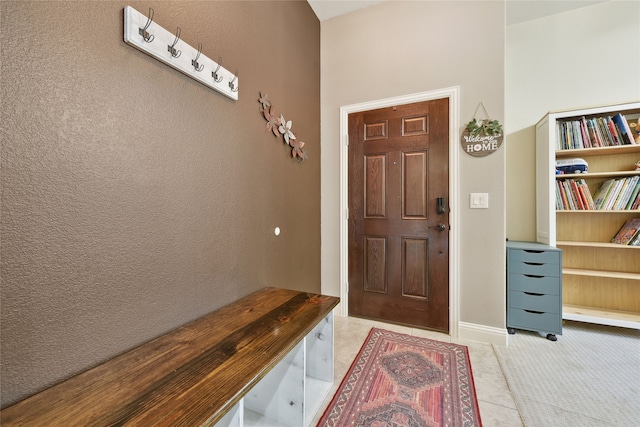 foyer entrance with light tile patterned floors