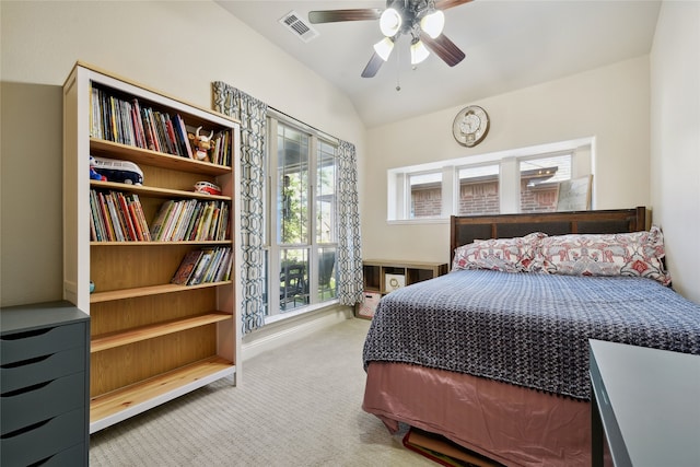 carpeted bedroom featuring vaulted ceiling, visible vents, and ceiling fan