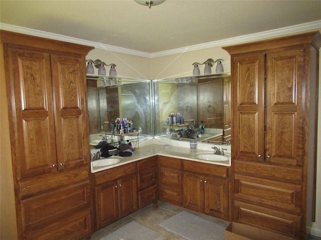 bathroom featuring double vanity, tile patterned floors, crown molding, and a sink