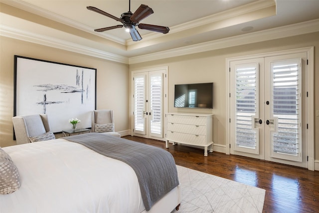 bedroom featuring access to exterior, a tray ceiling, and french doors