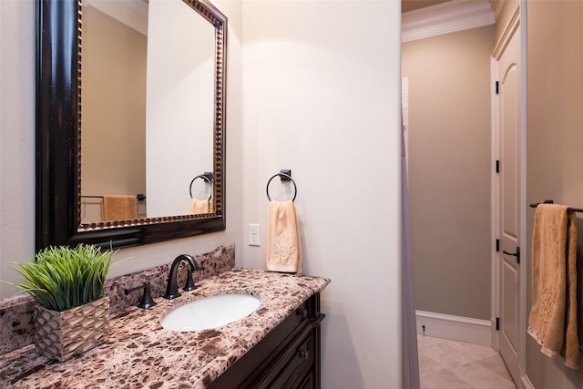 bathroom with vanity, crown molding, baseboards, and marble finish floor