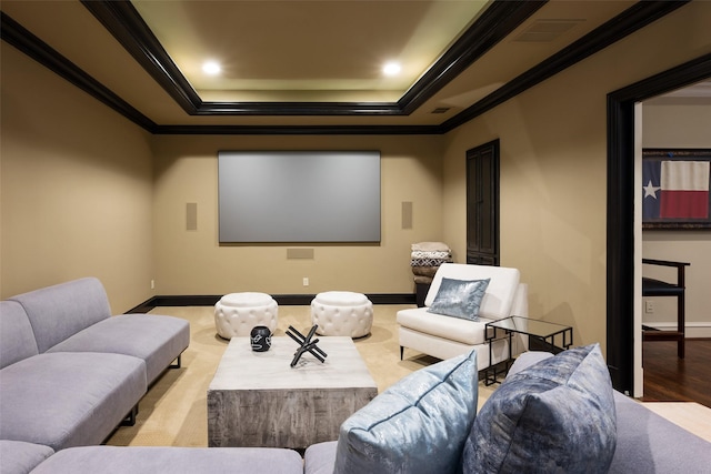 cinema with recessed lighting, baseboards, a raised ceiling, and ornamental molding