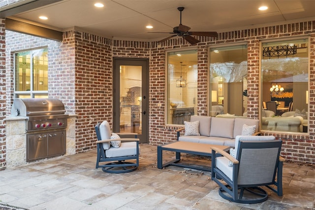 view of patio featuring an outdoor living space, grilling area, an outdoor kitchen, and a ceiling fan