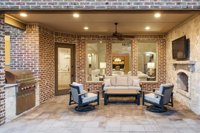 view of patio / terrace featuring an outdoor living space with a fireplace, an outdoor kitchen, a grill, and a sink