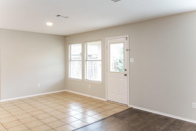 doorway to outside with light wood-style flooring, recessed lighting, visible vents, and baseboards