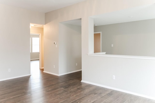 empty room with baseboards and wood finished floors