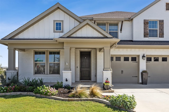 view of front of house featuring a garage, brick siding, board and batten siding, and concrete driveway