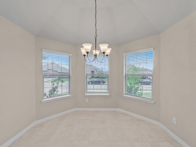 unfurnished room with light tile patterned floors, baseboards, and an inviting chandelier