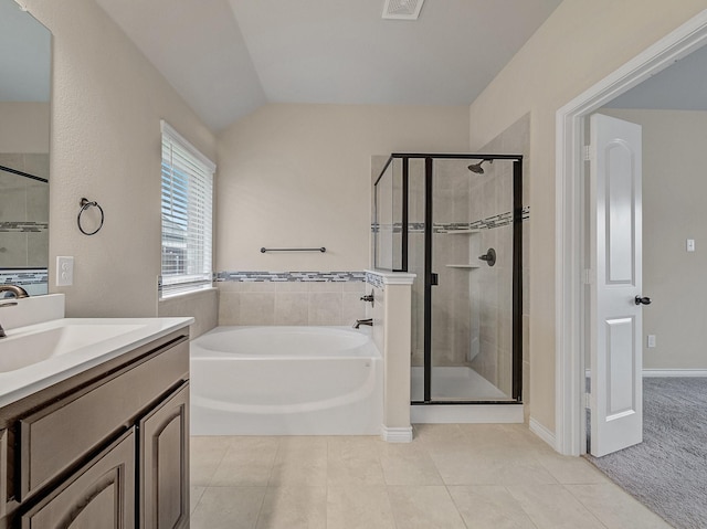 bathroom featuring a garden tub, a stall shower, vanity, and tile patterned flooring