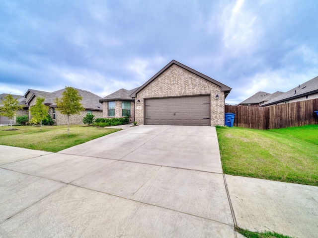 ranch-style home featuring brick siding, fence, concrete driveway, a front yard, and an attached garage