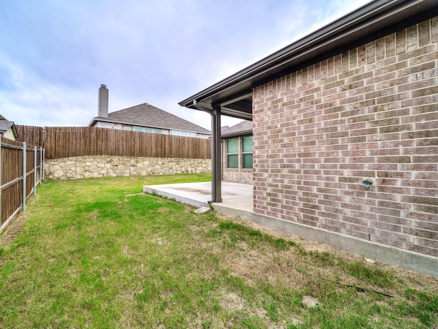 view of yard featuring a patio area and a fenced backyard