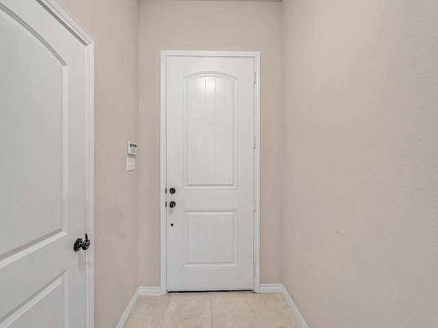 doorway to outside featuring baseboards