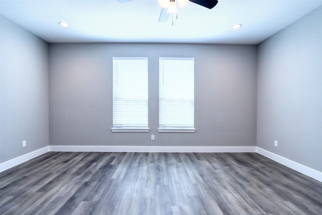 empty room with recessed lighting, baseboards, and dark wood-style flooring