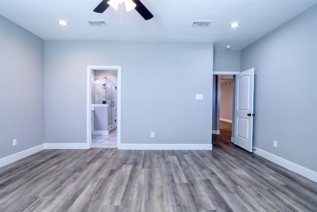 unfurnished bedroom featuring recessed lighting, wood finished floors, visible vents, and baseboards