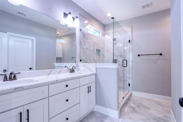 full bath with a stall shower, baseboards, visible vents, and a sink