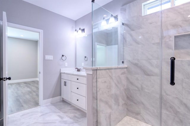 bathroom featuring a shower stall, vanity, and baseboards