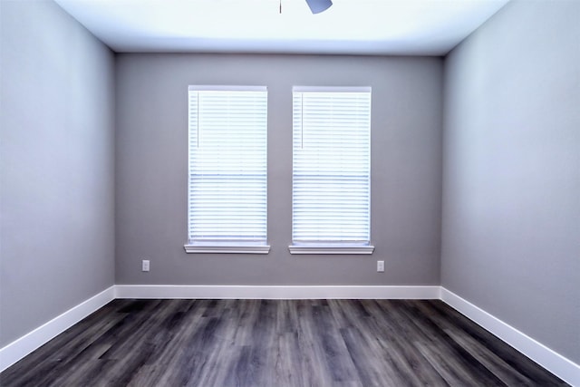 unfurnished room with dark wood-style floors, baseboards, and ceiling fan