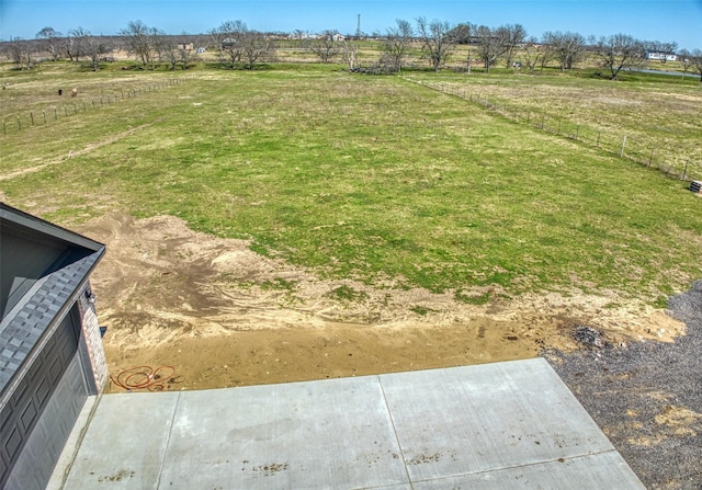 view of yard with a rural view and a garage