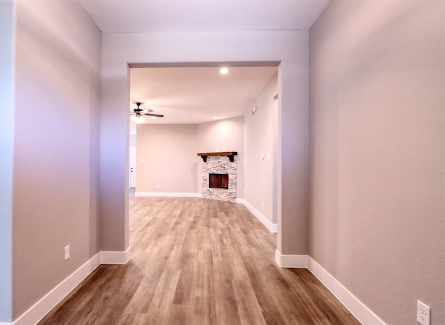 hallway featuring baseboards and light wood-type flooring