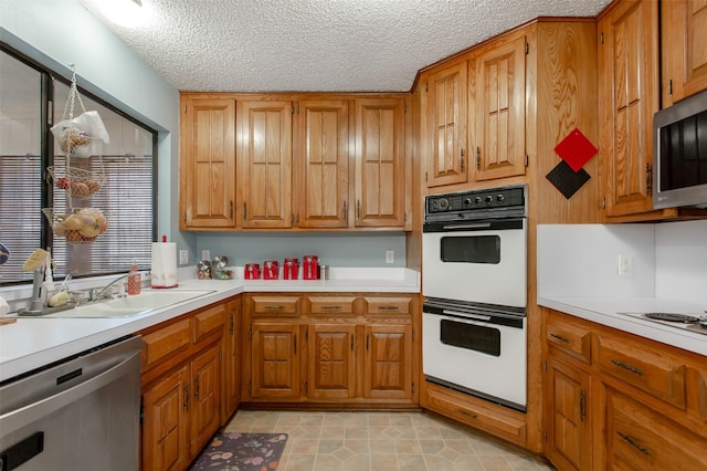 kitchen featuring brown cabinetry, appliances with stainless steel finishes, and light countertops