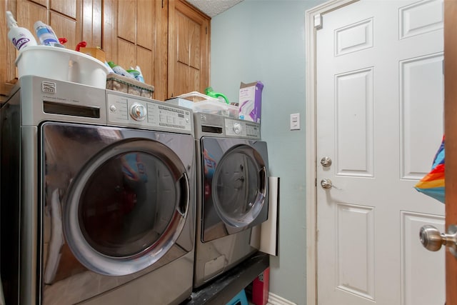 laundry area featuring cabinet space and independent washer and dryer