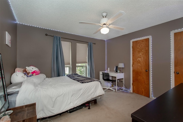 bedroom with carpet flooring, a textured ceiling, and ceiling fan