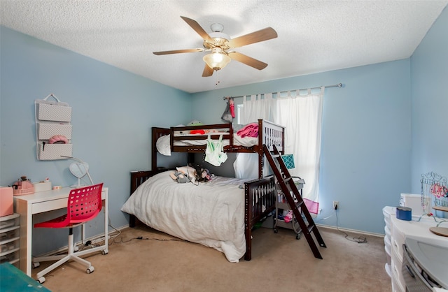 bedroom with baseboards, carpet floors, a textured ceiling, and a ceiling fan