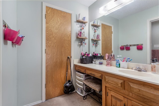 bathroom with vanity and a textured ceiling