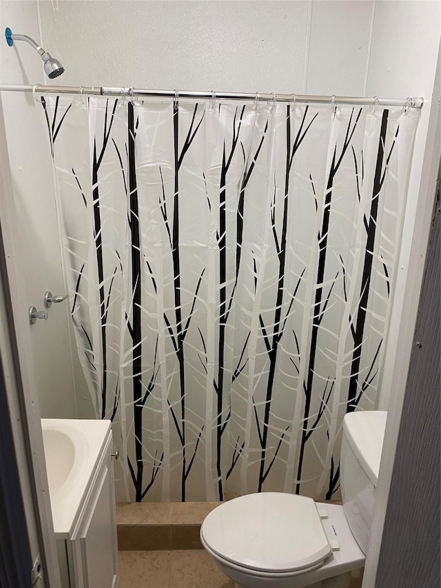 bathroom featuring tile patterned floors, curtained shower, toilet, and vanity